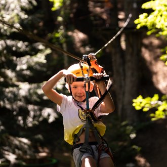 Enfant sur la tyrolienne du Parcours Kids